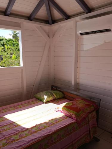 a room with two beds and a window at Chez Patrick in Sainte-Rose