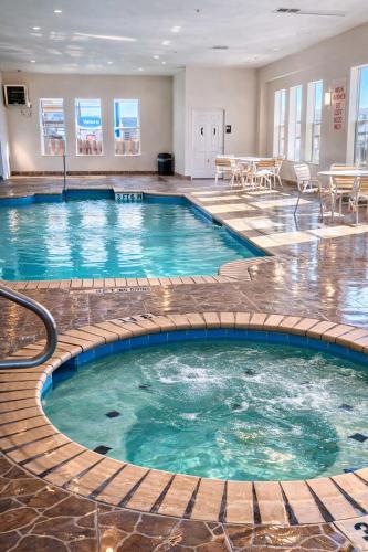 a pool in a hotel room with blue water at La Quinta by Wyndham Kerrville in Kerrville