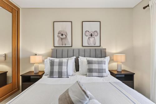 a bedroom with a large bed with two lamps at Townhouse Sasha in Almancil