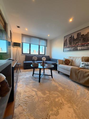 a living room with a couch and a table at VIP apartment paddington in London