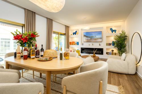a living room with a table and chairs at Alojamento Costa Alentejana in Zambujeira do Mar
