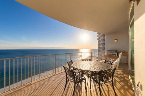 a balcony with a table and chairs and the ocean at Turquoise 1908C in Orange Beach