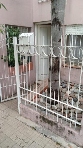 a fence in front of a building with a tree at a TRES MIN DEL CENTRO in Concordia