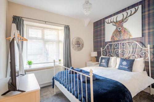 a bedroom with a bed and a picture of a deer on the wall at Wanderer's Rest in Lynton