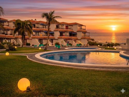 a resort with a swimming pool in front of the ocean at Lago Azul 59 SEA VIEW LOS CANCAJOS in Los Cancajos