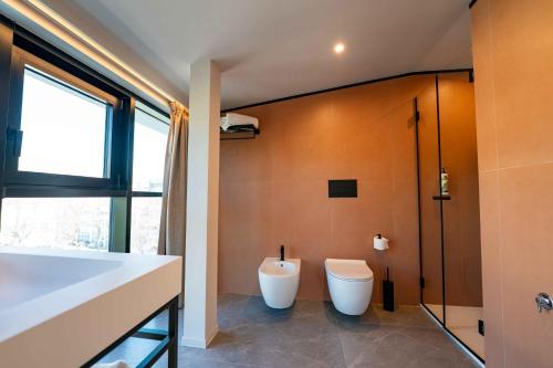 a bathroom with a toilet and a shower at Lamal Hotel Napoli in Naples
