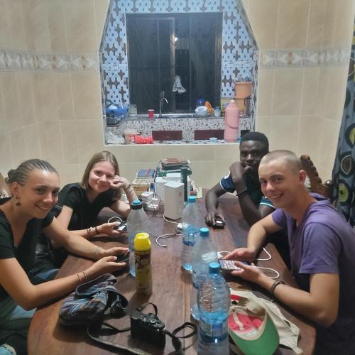 a group of people sitting around a table at Explore Rock city Mwanza in Mahango
