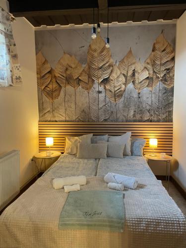 a bedroom with a large bed with two towels on it at Tér Pince in Sümeg