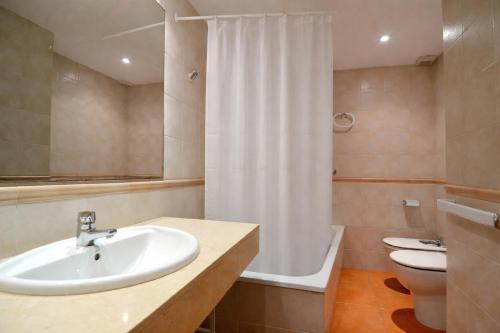 a bathroom with a sink and a toilet and a shower at GREEN MAR F 102 in Pals