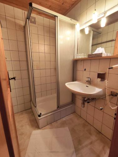 a bathroom with a shower and a sink at Stockerhütte - Ferienhaus in Vorderstoder