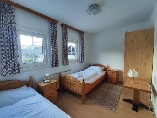 a bedroom with two beds and a window at Stockerhütte - Ferienhaus in Vorderstoder