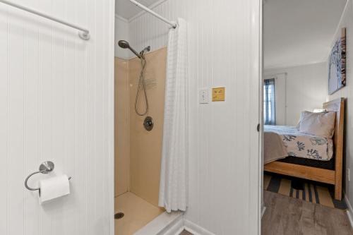 a bathroom with a shower and a bed at Lovely 2 bedroom condo with ocean view 304- 3rd Floor No Elevator in Myrtle Beach