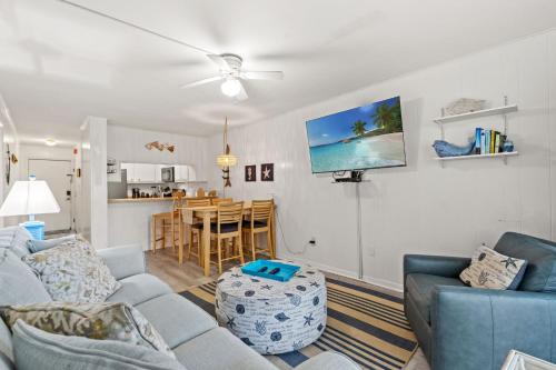 a living room with two couches and a kitchen at Lovely 2 bedroom condo with ocean view 304- 3rd Floor No Elevator in Myrtle Beach