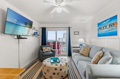 a living room with a couch and a table at Lovely 2 bedroom condo with ocean view 304- 3rd Floor No Elevator in Myrtle Beach