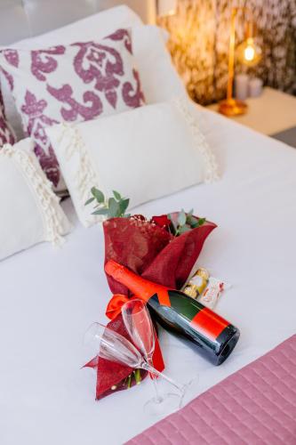 a white bed with a red ribbon and a pen at BestVillas Park Ofir in Esposende