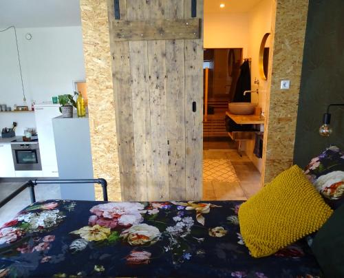 a bedroom with a bed and a wooden door at Luxurious appartement with sauna and kitchen in center of Dordrecht in Dordrecht