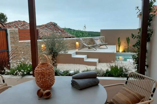 a table with a vase sitting on top of a patio at Viladraga - Casa da Ursa in Colares