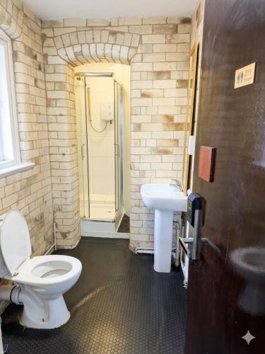 a bathroom with a toilet and a sink at Parkview Residence in Manchester