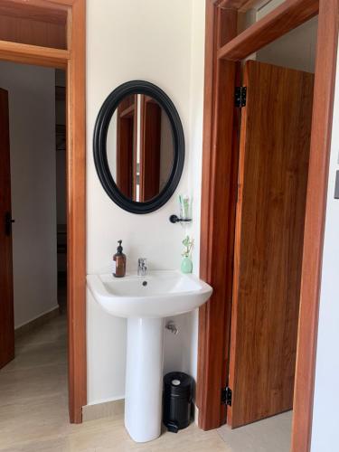 a bathroom with a sink and a mirror at Kgcottage in Nairobi