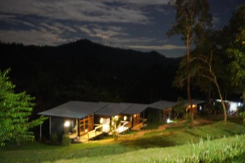 a house lit up at night in a field at Phu Pha View Doi in Samoeng