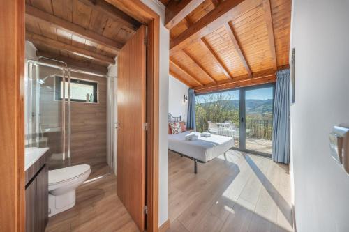 a bathroom with a sink and a toilet and a window at Casa da Portazinha - by Proguest in Amares