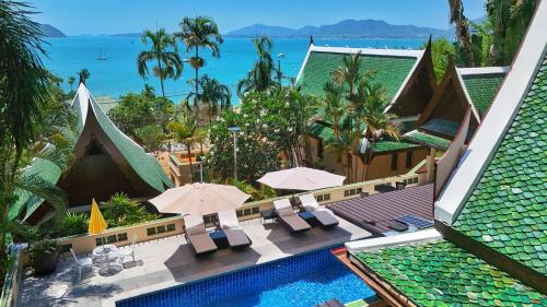 an aerial view of a resort with a swimming pool and the ocean at D Villa Phuket - Luxury 6 Bedroom Private Pool Villa in Cape Panwa in Phuket