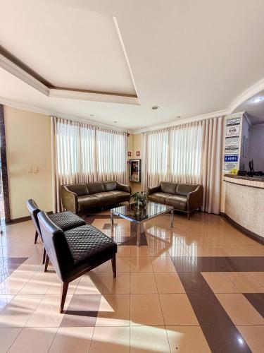 a large living room with couches and a table at Canadá Hotel in Rio Verde