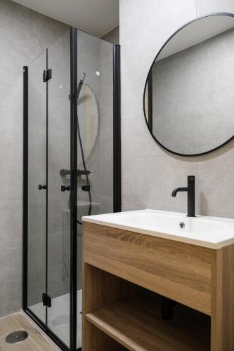 a bathroom with a sink and a mirror at Micampus Estanislao del Campo, Student Residence in Seville