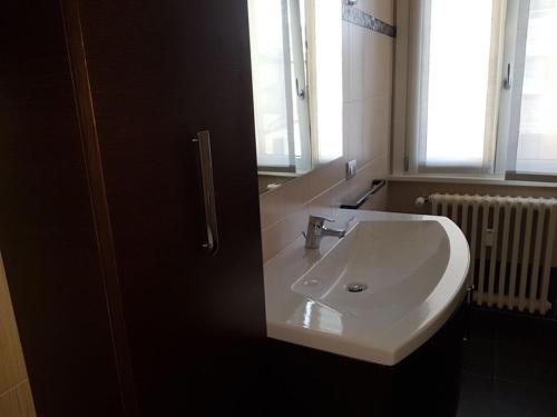 a bathroom with a white sink and a window at Il Ciano in Sondrio