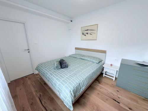 a bedroom with a cat laying on a bed at A & B apartment in Lovran