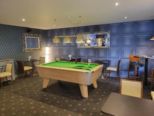 a room with a pool table in a restaurant at North Kessock Hotel in Inverness