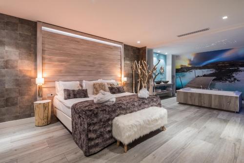 a large bedroom with a large bed and a tub at Van der Valk Hotel Utrecht in Utrecht