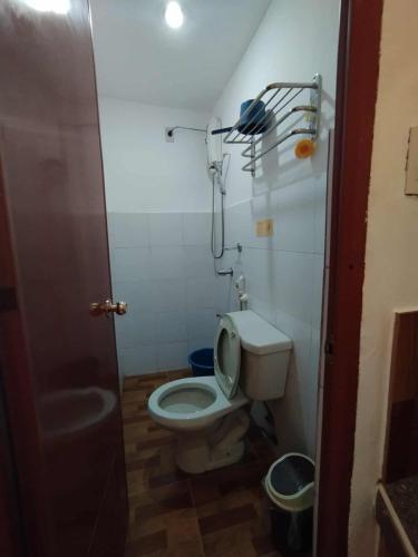 a small bathroom with a toilet and a shower at RenSea Haven Boracay in Boracay