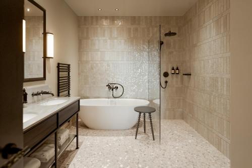 a bathroom with a tub and two sinks and a shower at The Kithmore in St. Andrews