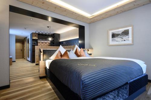 a bedroom with a large bed in a room at Hotel Tirol in Ischgl