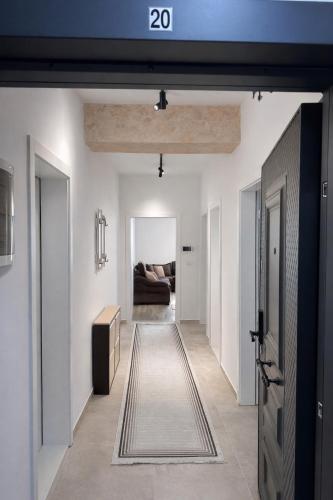 a hallway leading to a living room with a couch at Dialb Apartments in Debar