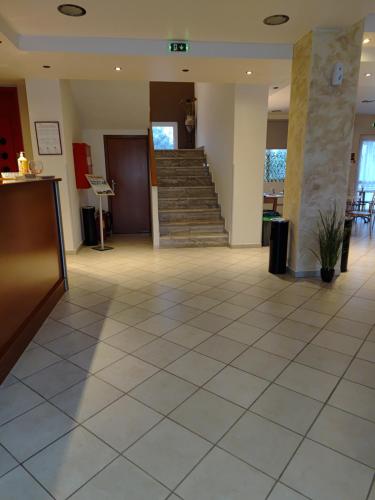 a lobby with a staircase in a building at Hotel Isidora in Loutrós