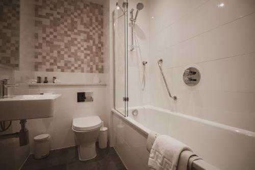 a bathroom with a toilet and a sink and a shower at Merewood Country House Hotel in Windermere