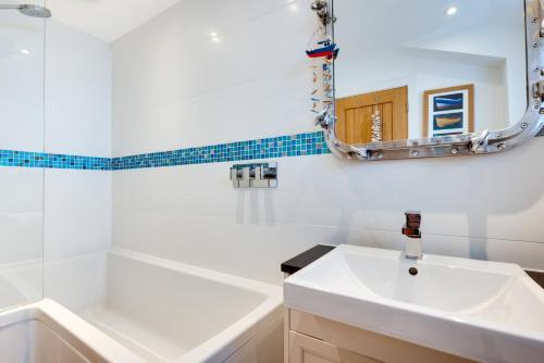 a bathroom with a sink and a mirror at 2 Bed in Polruan oc-p00896 in Polruan