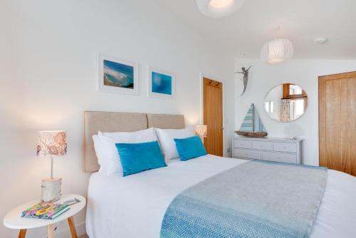 a bedroom with a large white bed with blue pillows at 2 Bed in Polruan oc-p00896 in Polruan
