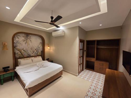 a bedroom with a bed and a ceiling fan at ANVI Homestay in Bhopal