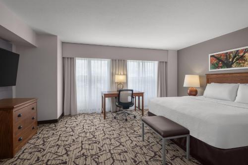 a hotel room with a bed and a desk at Holiday Inn Stevens Point - Convention Center by IHG in Stevens Point