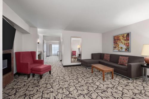 a living room with a couch and a chair at Holiday Inn Stevens Point - Convention Center by IHG in Stevens Point