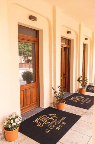 a pair of black rugs in front of a door at Albergo Al Cinghiale in Montevecchio