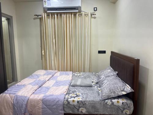 a bedroom with a bed with a tv on the wall at Beach front flat in Bhīmunipatnam