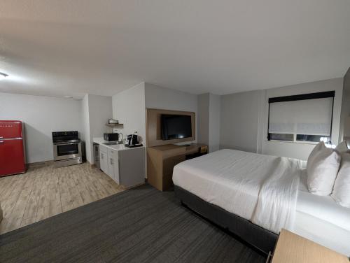 a hotel room with a bed and a television at Comfort Inn & Suites Golden - Denver West in Golden