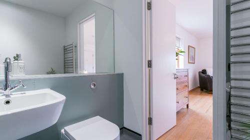 a bathroom with a sink and a toilet at Bath Cottage in Caernarfon