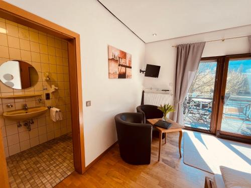 a room with a bathroom with a sink and a mirror at Hotel zum Anker in Detzem