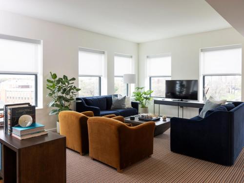 a living room with couches and a tv at The Study at Johns Hopkins in Baltimore