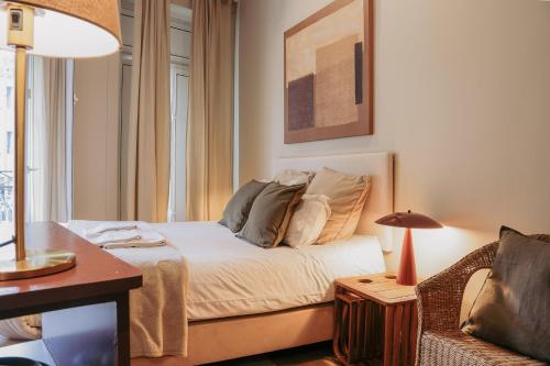 a bedroom with a bed and a couch and a table at Impar Studios in Porto